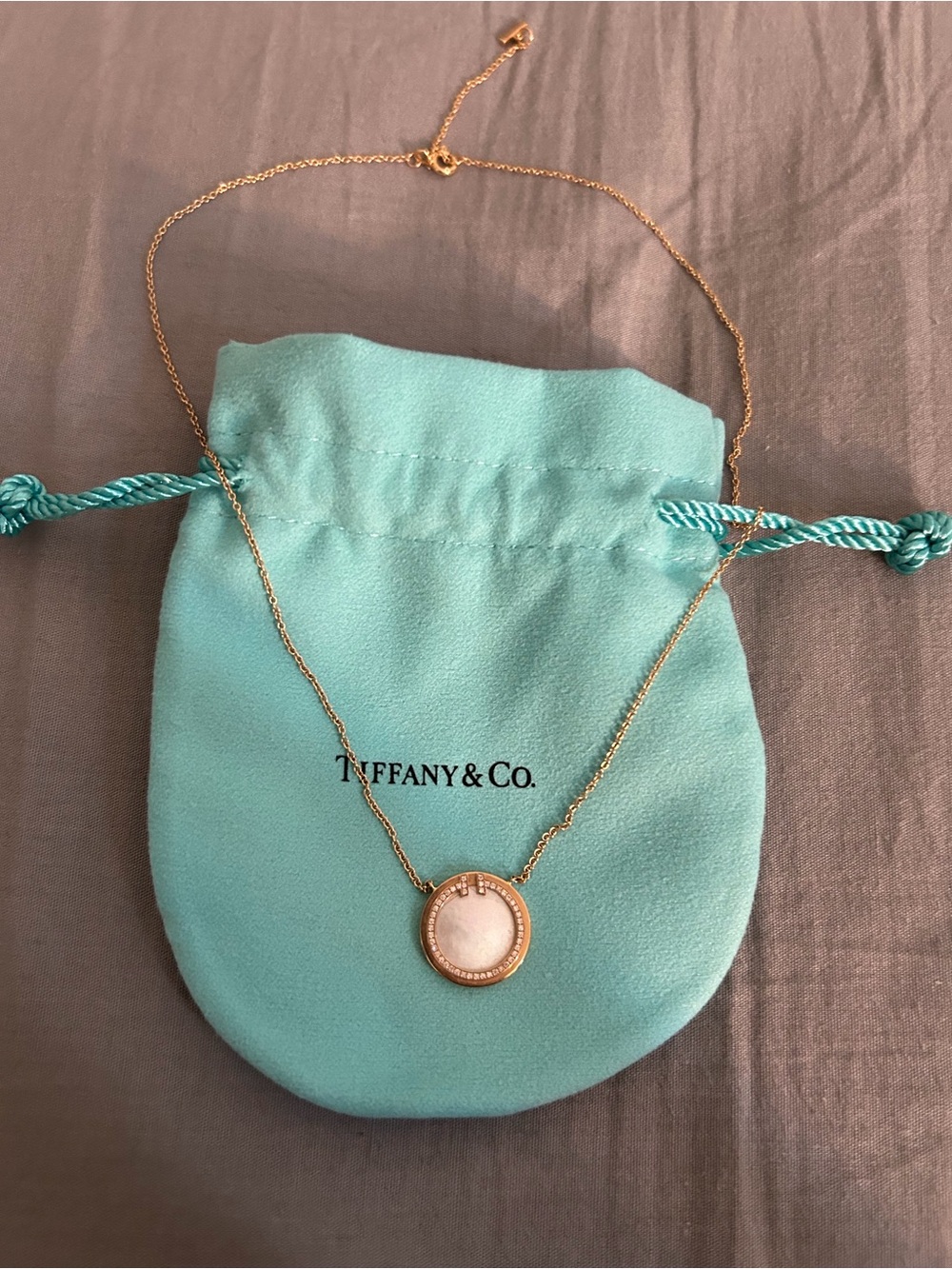 Tiffany & Co. Gold Pendant Necklace with White Center and Aqua Pouch